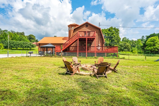 back of house with a gazebo, a yard, a deck, and an outdoor fire pit