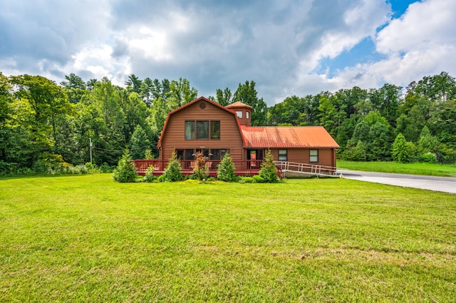 log-style house with a front yard and a deck