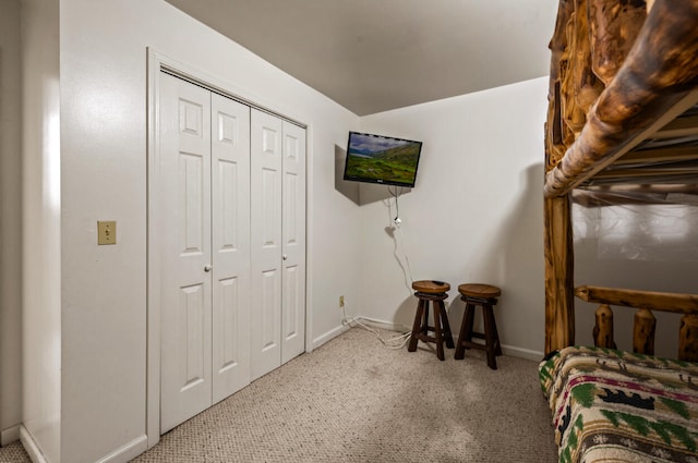 bedroom featuring light carpet and a closet