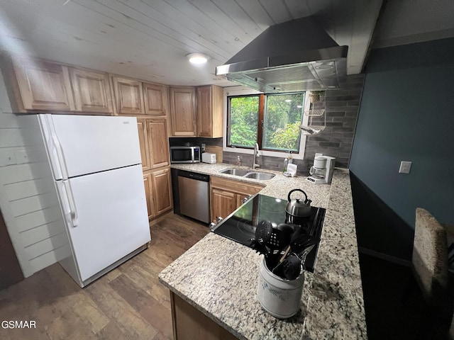 kitchen featuring island range hood, wood-type flooring, sink, light stone counters, and stainless steel appliances