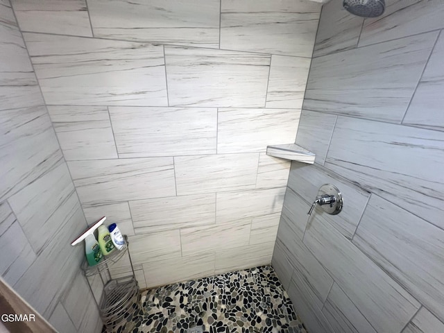 bathroom with a tile shower