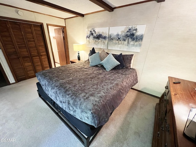 carpeted bedroom featuring beamed ceiling and a closet