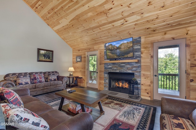 2319 Panther Way, Sevierville, TN 37876 - living area featuring wood finished floors, a stone fireplace, wooden ceiling, wood walls, and high vaulted ceiling