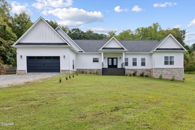 view of front of property with a garage, a front yard, and french doors