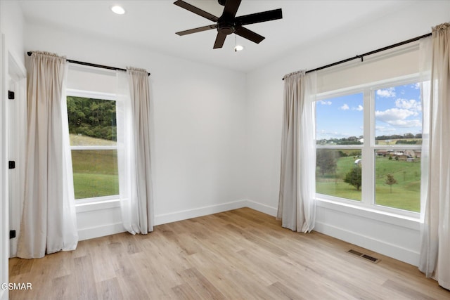 unfurnished room with ceiling fan and light hardwood / wood-style floors