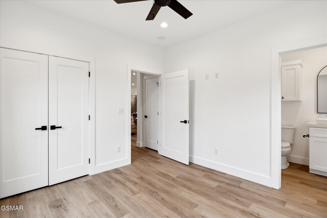 unfurnished bedroom with ensuite bath, ceiling fan, a closet, and light hardwood / wood-style floors