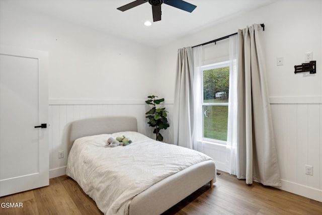 bedroom with hardwood / wood-style flooring and ceiling fan