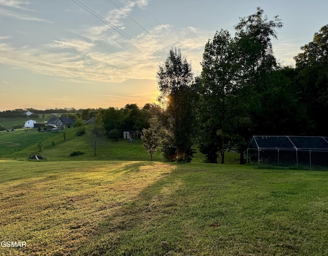 yard at dusk with a rural view