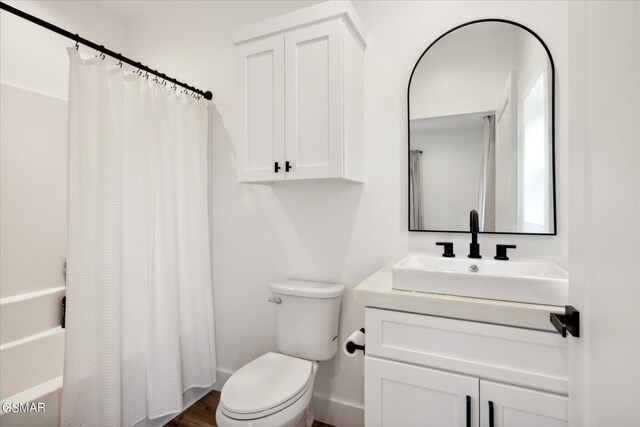 full bathroom with shower / bath combo, toilet, and vanity