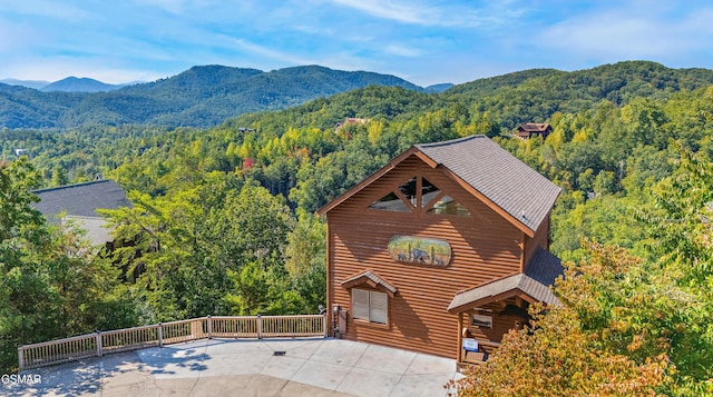 exterior space with a wooded view