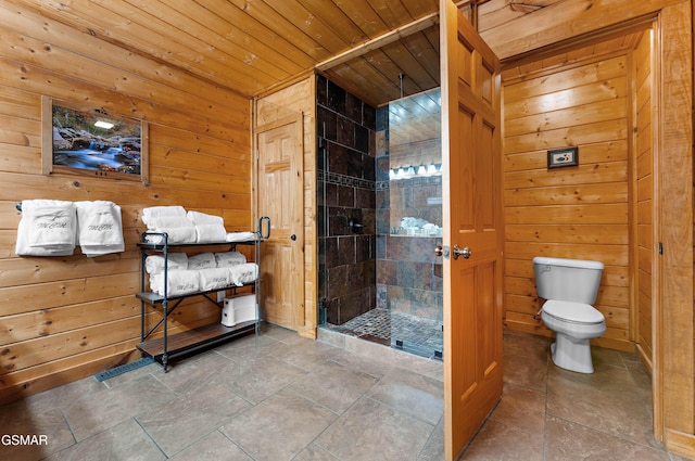 full bath featuring wood walls, wooden ceiling, toilet, and a stall shower