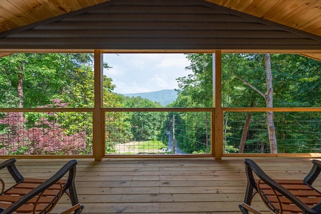 unfurnished sunroom featuring vaulted ceiling