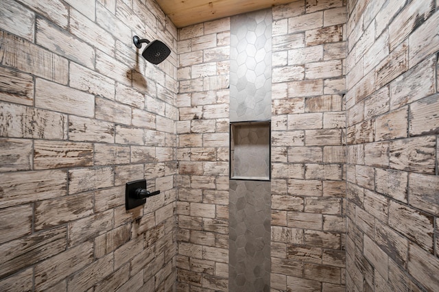 bathroom with a tile shower and wood ceiling