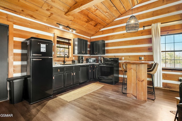 kitchen featuring dark wood finished floors, lofted ceiling, wood ceiling, black appliances, and a sink