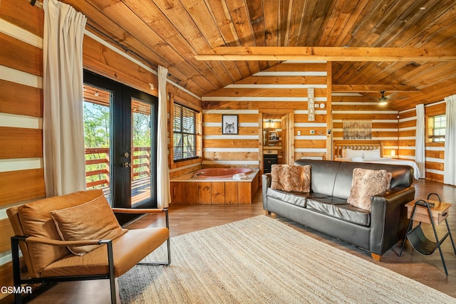 living room featuring lofted ceiling, wood ceiling, wood finished floors, french doors, and wood walls