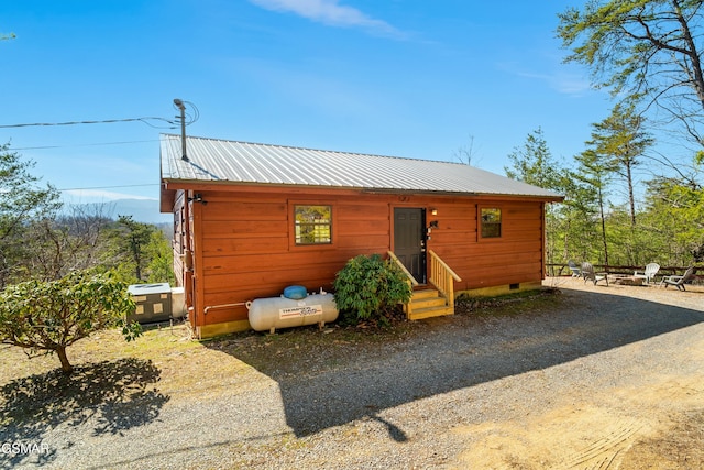 chalet / cabin featuring entry steps, driveway, crawl space, and metal roof