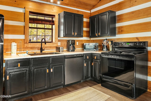 kitchen with dark cabinets, black range with electric cooktop, dishwasher, and a sink