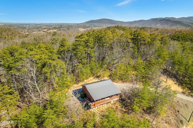 drone / aerial view with a mountain view and a view of trees