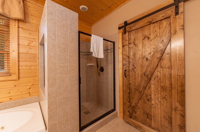 2837 Cedar Falls Way, Sevierville, TN 37862 - bathroom with a garden tub, a stall shower, wooden ceiling, wood walls, and tile patterned flooring