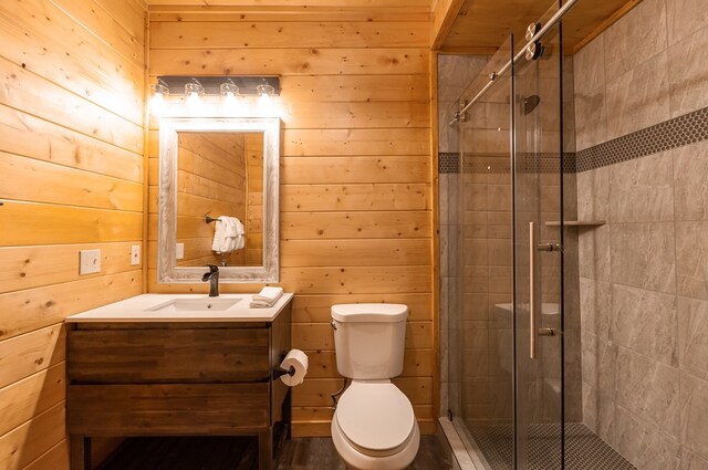 2837 Cedar Falls Way, Sevierville, TN 37862 - bathroom featuring vanity, toilet, wood walls, and a shower stall
