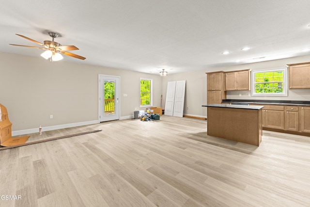 1039 Cedar Ln, Sevierville, TN 37862 - kitchen featuring a kitchen island, open floor plan, light wood-style floors, dark countertops, and recessed lighting