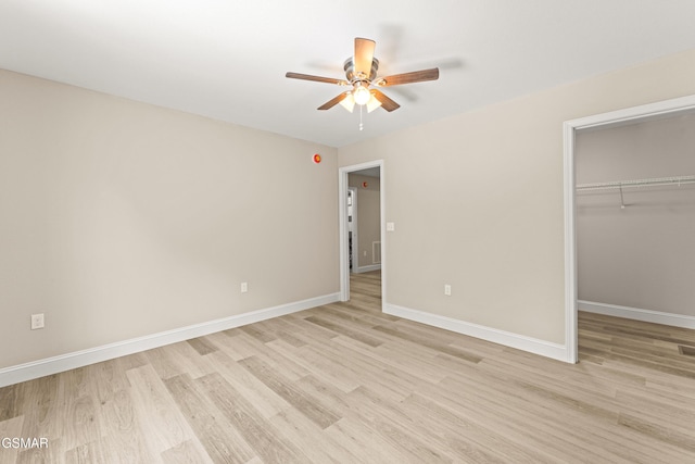 1039 Cedar Ln, Sevierville, TN 37862 - unfurnished bedroom with light wood-type flooring, a closet, a spacious closet, and a ceiling fan