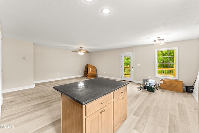 1039 Cedar Ln, Sevierville, TN 37862 - kitchen featuring open floor plan, light wood-style floors, a kitchen island, a ceiling fan, and light brown cabinets