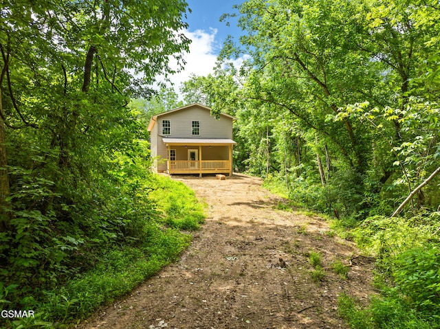 1039 Cedar Ln, Sevierville, TN 37862 - view of front of home featuring driveway, covered porch, and a wooded view