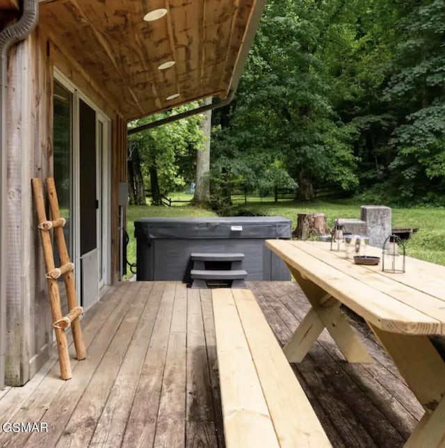 wooden terrace featuring a hot tub