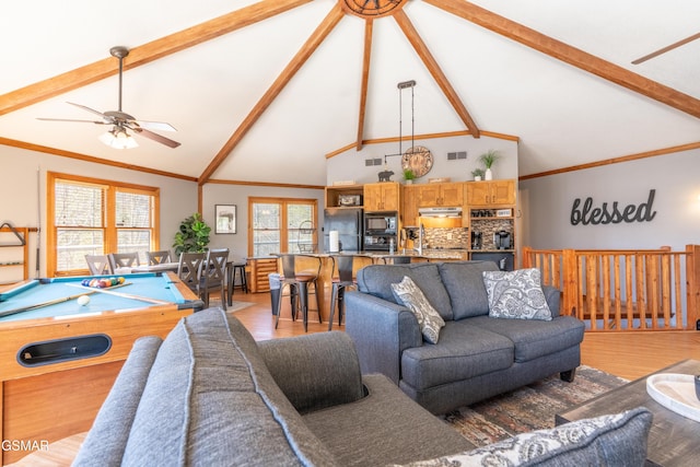 living room with beam ceiling, light wood-type flooring, visible vents, and crown molding