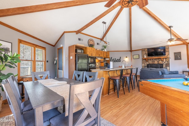 dining space with visible vents, a ceiling fan, light wood-style flooring, ornamental molding, and beamed ceiling