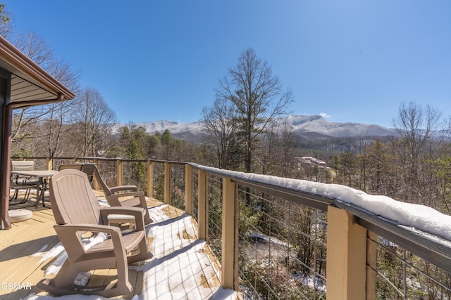 balcony with outdoor dining area and a deck with mountain view