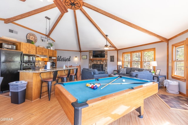 recreation room featuring ornamental molding, beam ceiling, visible vents, and light wood-style flooring