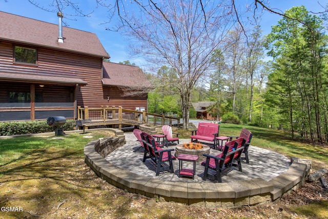 2754 Owls Cove Way, Sevierville, TN 37862 - view of grassy yard with an outdoor fire pit, a deck, and a patio area