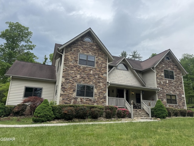 2754 Owls Cove Way, Sevierville, TN 37862 - craftsman house featuring stone siding, a porch, and a front lawn