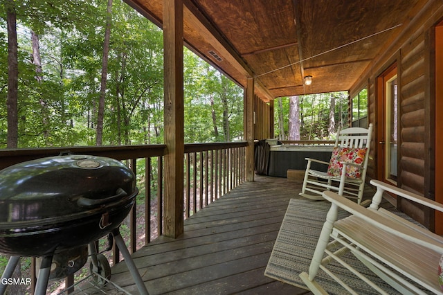 wooden terrace featuring a hot tub and grilling area