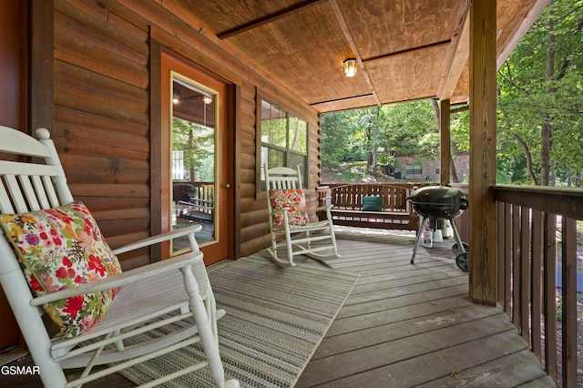 wooden terrace with covered porch and grilling area