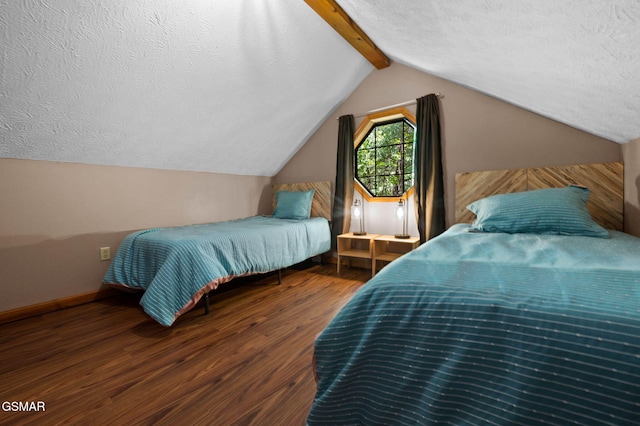 bedroom with dark wood-type flooring, vaulted ceiling with beams, a textured ceiling, and baseboards