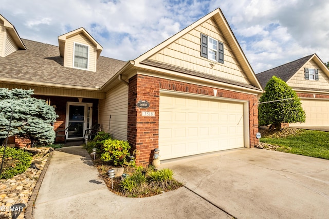 3518 Pebblebrook Way, Knoxville, TN 37921 - view of front of home featuring brick siding, driveway, roof with shingles, and a garage