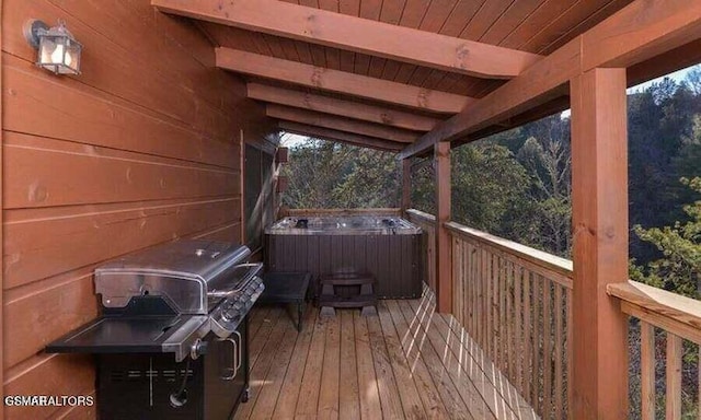 wooden deck featuring a grill and a hot tub