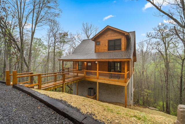 back of house with central AC unit