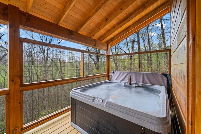 sunroom with wood ceiling, a hot tub, and lofted ceiling with beams