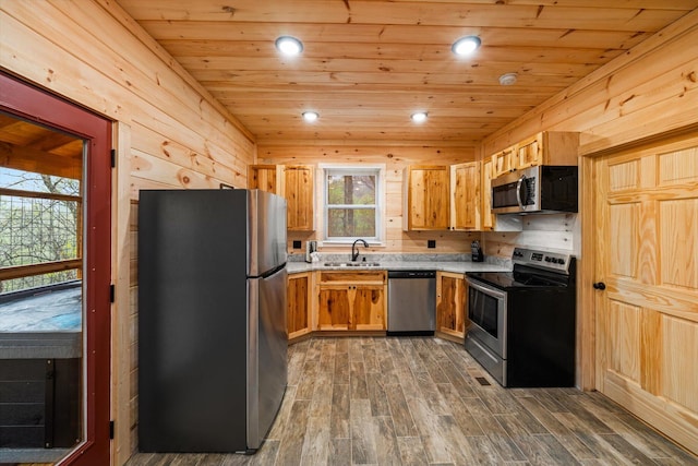 kitchen featuring appliances with stainless steel finishes, sink, wooden ceiling, and dark hardwood / wood-style flooring