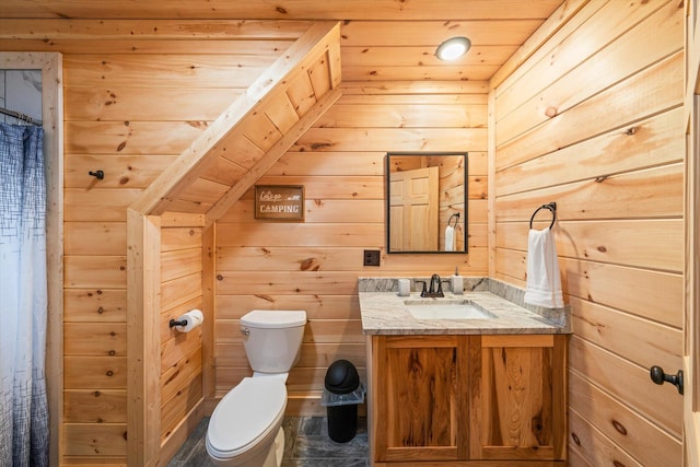 bathroom with vanity, wood walls, wood ceiling, and toilet