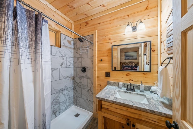 bathroom with vanity, wood walls, and walk in shower