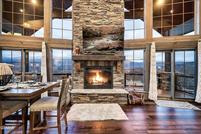710 Wiley Oakley Dr, Gatlinburg, TN 37738 - dining area with wood finished floors, a stone fireplace, and a high ceiling