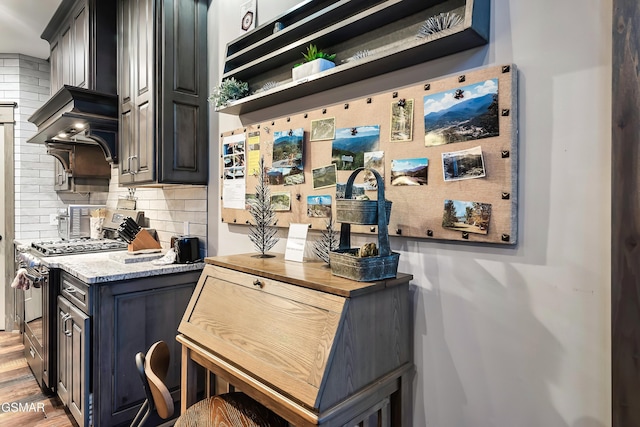 710 Wiley Oakley Dr, Gatlinburg, TN 37738 - kitchen with gas stove, tasteful backsplash, light wood-style floors, and light stone countertops