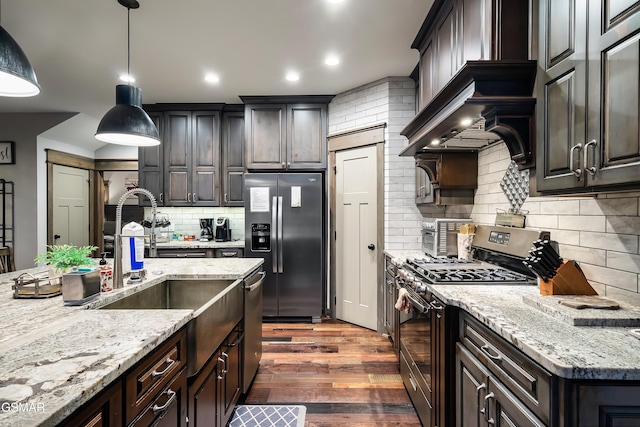 710 Wiley Oakley Dr, Gatlinburg, TN 37738 - kitchen featuring stainless steel appliances, wood finished floors, decorative backsplash, a sink, and light stone countertops