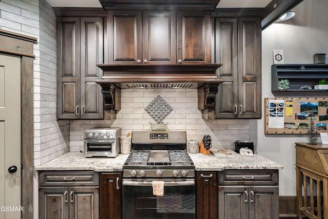 710 Wiley Oakley Dr, Gatlinburg, TN 37738 - kitchen featuring gas range, decorative backsplash, dark brown cabinetry, and light stone countertops