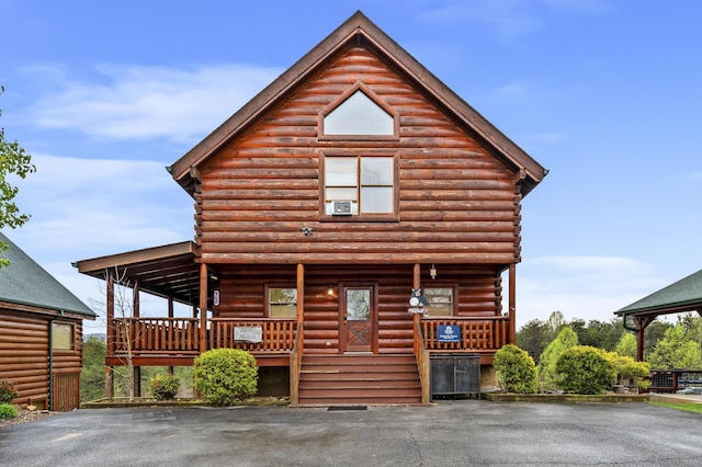 log cabin featuring covered porch